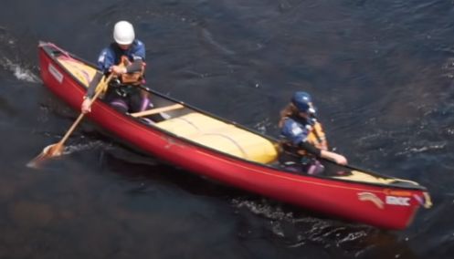 A photo of a canoe in moving water.